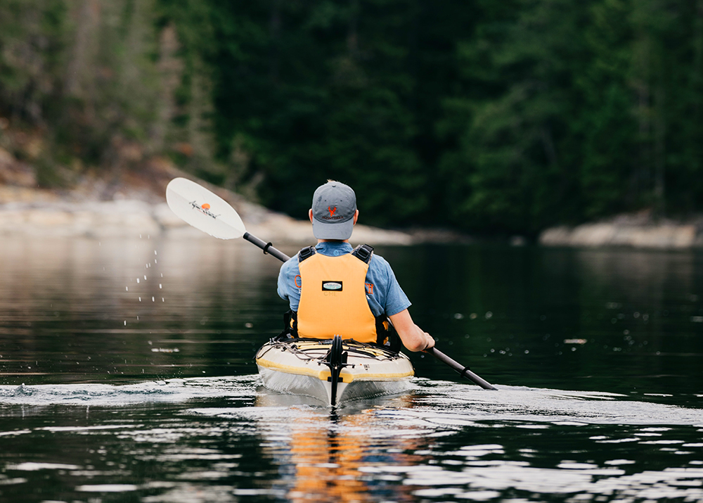 man paddling on a kayak