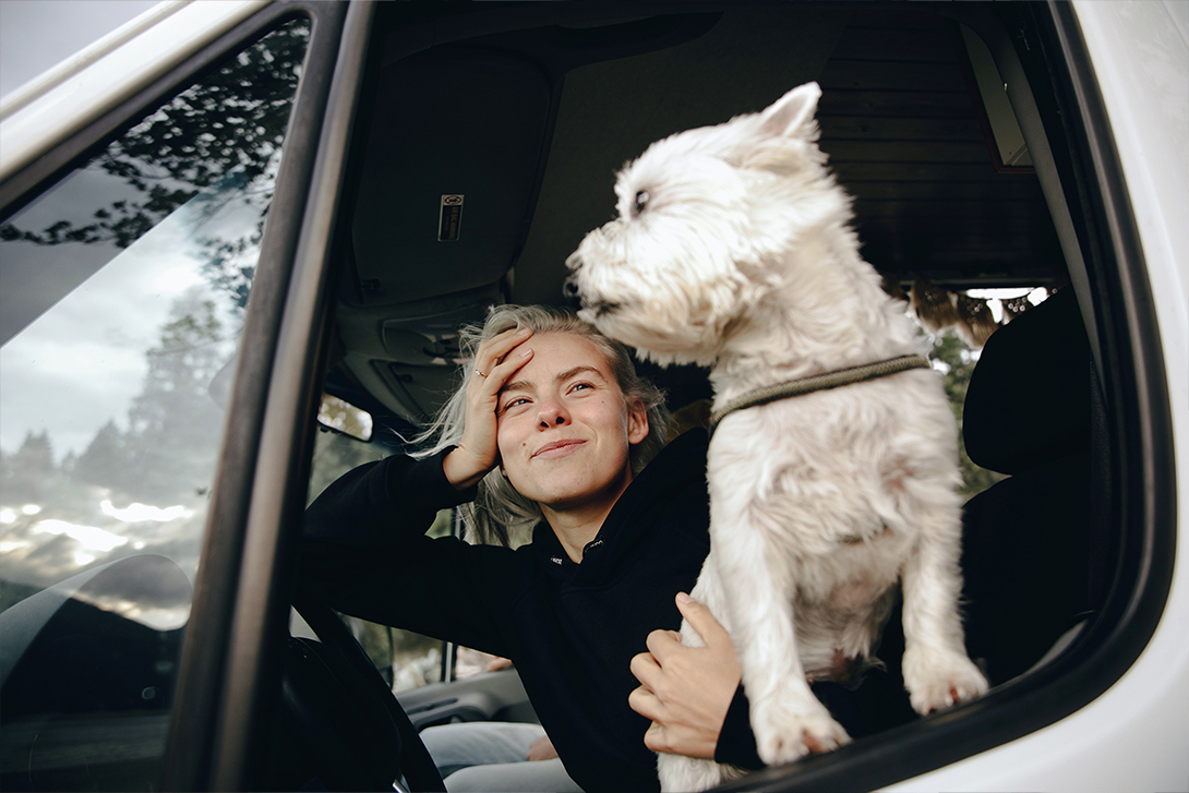 woman and her dog in a camper van